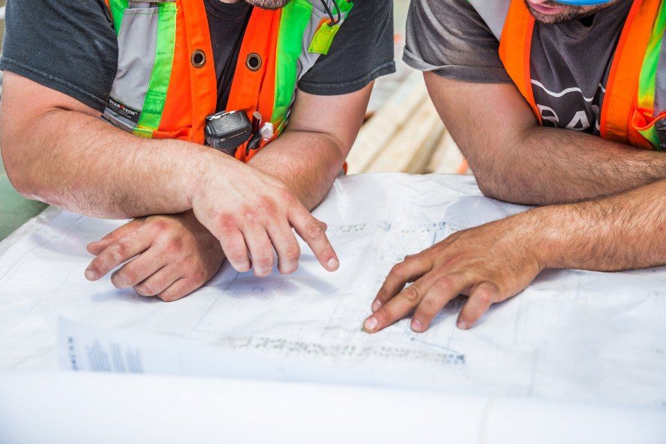 Trades crew reviewing blueprints